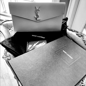 An Yuves Saint Laurent clutch in gray leather